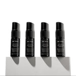 Four black bottles of Mr. Muk styling powder on a white background